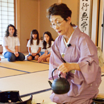 A Japanese arts camp for children is among the auction items. Kimiko Gunji, director of Japan House, presents the tea ceremony for campers.