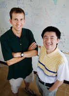 Harley Johnson, left, a mechanical science and engineering professor, and Dong Xiao, a postdoctoral researcher, have demonstrated an approximate cloaking effect created by concentric rings of silicon photonic crystals.