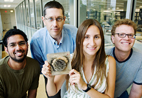 Working on the wasp genetics study were, from left, graduate student Kranthi Varala; Gene Robinson, professor of entomology; postdoctoral researcher Amy Toth (holding a wasp nest); and Matthew Hudson, professor of crop sciences.