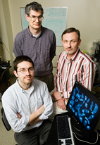 Research specialist Dmitri V. Novikov, right, with graduate student Mert Dikmen, left, and professor Andrew Belmont, all in the cell and developmental biology department, have developed a simple and economical technique for imaging and mapping fruit fly chromosomes (on the screen).