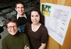 Sydney Cameron, professor of entomology, left, with graduate student Heather Hines and undergraduate Timothy O'Connor have conducted a genetic analysis of vespid wasps that revises the vespid family tree and challenges long-held views about how the wasps' social behaviors evolved. The wasp family tree is posted on the door.