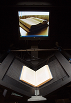 Draped with black canvas, the scanners look something like oversized beach cabanas. Books are perched in a V-shaped holder, while two digital cameras above them photograph the pages - at super-high resolution for about 10 cents per page. A technician turns the pages and maintains the cameras.