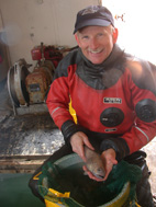 Kevin Hoefling holds Cryothenia amphitreta, the Antarctic fish he and research specialist Paul A. Cziko discovered in McMurdo Sound in November 2004.