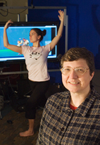 Klara Nahrstedt, professor of computer science, is collaborating on a new video-conferencing method that is more sophisticated and cheaper. Graduate student dancer Renata Sheppard is in the background.