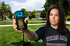 Laura Beach, a May graduate in human development and family studies in the College of Agricultural, Consumer and Environmental Sciences and staff member with the Prairie Flowers science outreach program, displays one of four global positioning receivers that will be contained in instructional kits available to teachers in Illinois middle schools. GPS technology can be used in activities such as geocaching, a form of treasure hunting, and ecocaching, which teaches children about the Earth and its history through visits to natural and historic sites.