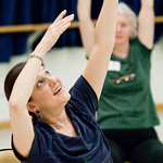 Kate Kuper, a visiting lecturer in the department of dance, leads Dance for Parkinson╒s class participants in seated exercises. Kuper said the aesthetic workout promotes a sense of self.