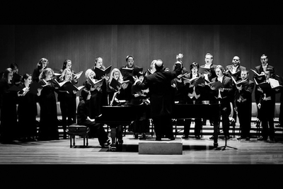 Black and white photo of a choral ensemble onstage.