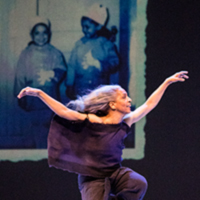 Photo of a dancer dressed in black leaping across a stage, with a projected image of a photo of two children in the background.