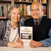 Photo of Kate Williams-McWorter and Gerald McWorter sitting together and holding a copy of their book 