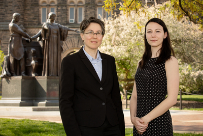 Educational psychology professor Jennifer Cromley and graduate student Andrea Kunze standing outdoors