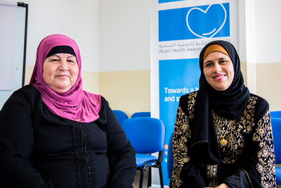 Two women who participated in the program stand in the clinic that hosted the program.