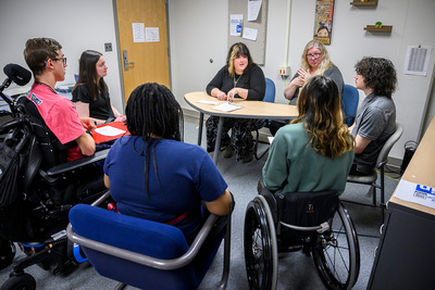 students with disabilities participate in a group discussion about their goals and plans with staff members from Disability Resources and Educational Services