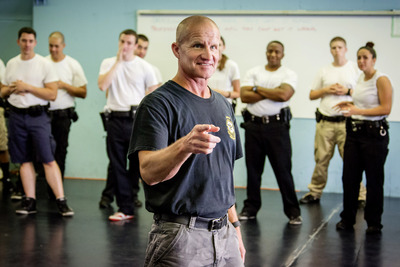 PTI Director Michael Schlosser presents to police recruits at the Police Training Institute.