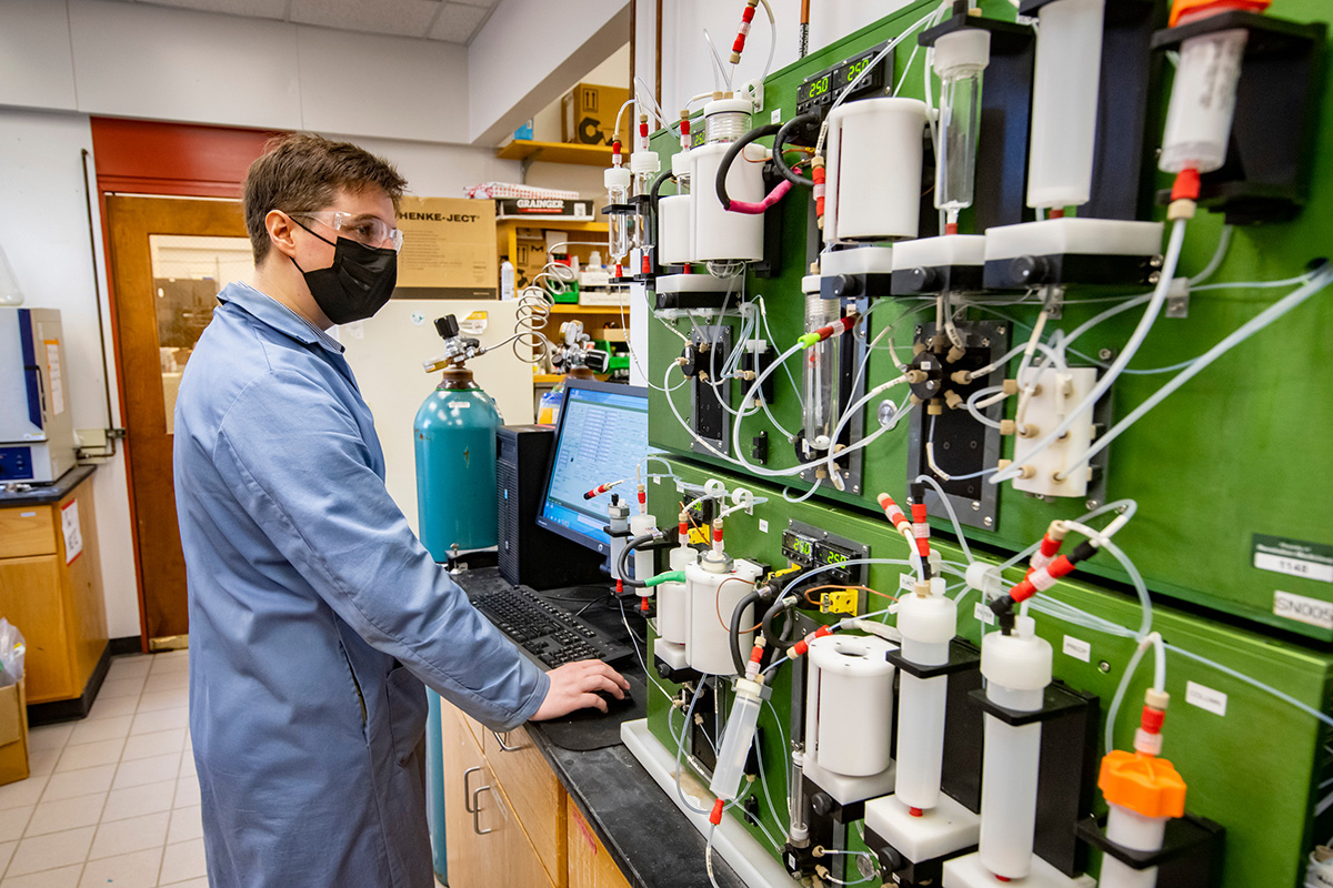 Researcher standing near molecule machine