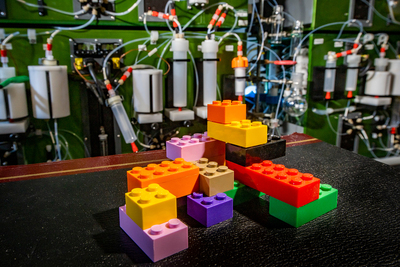A pile of oversized Legos in front of the molecule machine