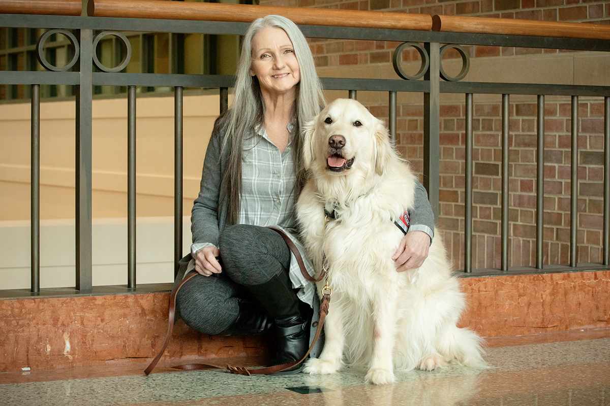 Beckman Institute researcher Joey Ramp poses with her dog, Sampson.