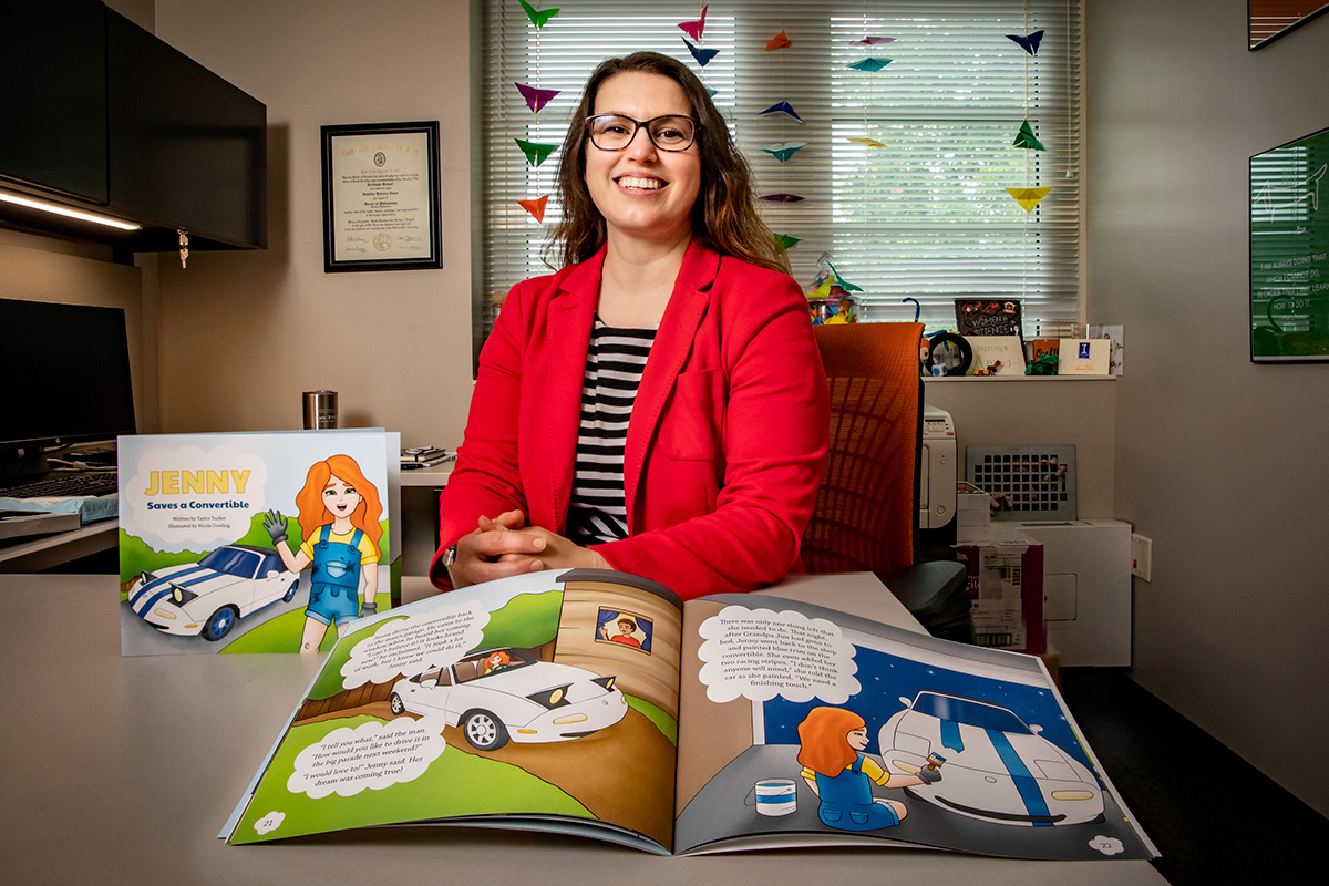 Bioengineering professor Jennifer Amos displays the children's book "Jenny Saves a Convertible," published through a project with Illinois Engineering Ambassadors.