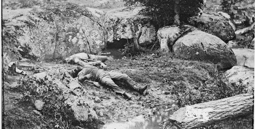 Photos of the carnage from Gettysburg and other Civil War battles shocked many who saw them, but also provided a way to manage grief and trauma, says communication professor Cara Finnegan. At left, dead Confederate soldiers in the "slaughter pen" at the foot of Little Round Top at Gettysburg.