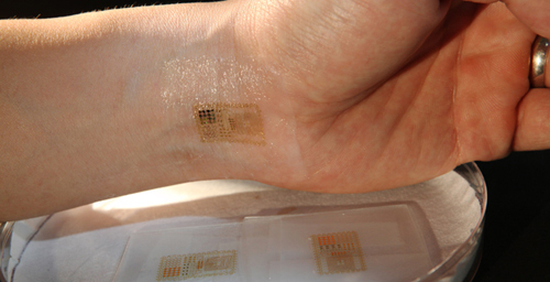 An ultrathin, electronic patch with the mechanics of skin, applied to the wrist for EMG and other measurements.