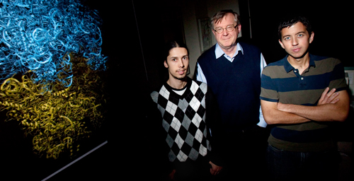 Physics professor Klaus Schulten and graduate student Leonardo Trabuco, left, and postdoctoral researcher James Gumbart, with model of a ribosome, are using the computer as a microscope to decipher the chemical details of ribosome function.