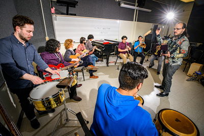 Photo of a group of musicians rehearsing.