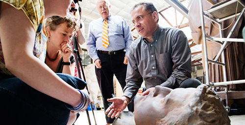 Head games Andrzej Dajnowski, the lead conservator with Conservation of Sculpture and Objects Studio, Forest Park, Ill., explains the disassembly process to a team from the U. of I. that is following the status of the work. Further work has shown that the Alma Mater statue actually comprises 48 pieces and was kept together with nearly 1,000 bolts and fasteners. The repaired statue is expected to return to campus in time for commencement 2014.  Click photo to enlarge