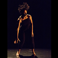 Image of a Black dancer with her hair flying up from her head.