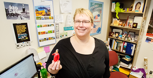 Laura Barnes, a librarian for the Prairie Research Institute and the executive director of the Great Lakes Regional Pollution Prevention Roundtable, shows off her librarian action figure, one of the many pieces in her office collection.