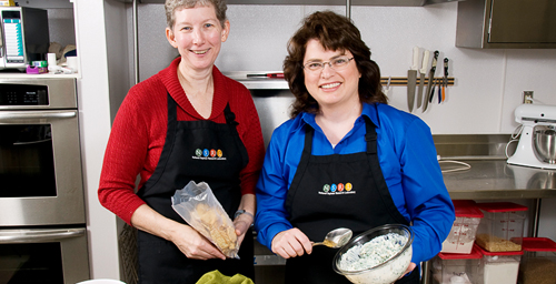 UI National Soybean Research Laboratory project coordinator Marilyn Nash, left, and research dietitian Stacey Krawczyk experiment with new recipes in the labs test kitchen. The two were involved in the effort with Midwest Food Bank to find ways to include donated soy ingredients into meal mixes that are distributed to local food banks for use by clients throughout Illinois and Indiana.