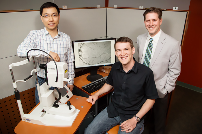 Dr. Stephen Boppart led a team that developed a new medical imaging device that can see individual cells in the back of the eye to better diagnose and track disease. From left: postdoctoral researcher Yuan-Zhi Liu, graduate student Fredrick A. South, and professor Stephen Boppart.