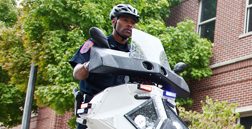 UI Police Officer James Carter demonstrates one of the new Sentinel transportation devices, which the department started using on the Urbana campus for the first time this fall. UIPD officers are using two Sentinels for basic patrol and crowd-control work, while students will be using them for the Safewalks program.
