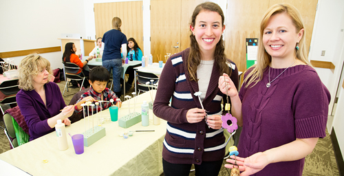 Pamela Hochwert, a senior in special education, standing left, and Michelle Bonati, a doctoral student in special education, at a Bens Bells event at Champaign Public Library.