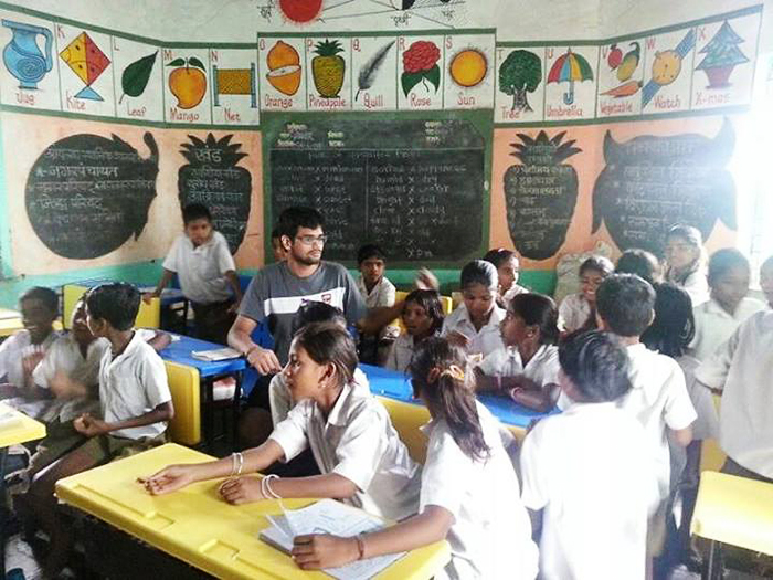 Coursera student Kunwar Apoorva Singh is surrounded by tribal children he taught in rural Maharashtra, a state in western India, as part of an outreach campaign supported by the NGO Don Bosco.