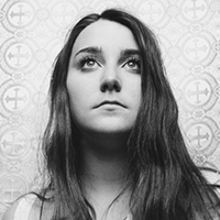 Black-and-white photo of Katie Pruitt against a patterned cloth.