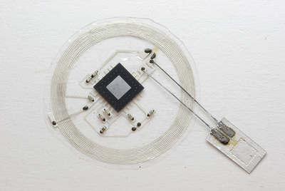The small sensor connects to an embeddable wireless transmitter that lies on top of the skull.