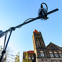 Photo of microphones on a stand with Altgeld Hall in the background.