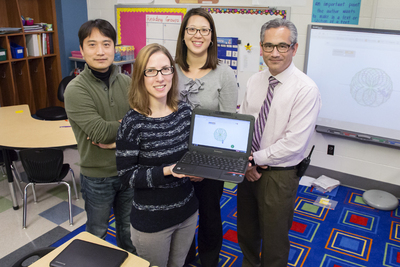 Researchers at Illinois and Champaign Unit 4 Schools are collaborating on a study that is exploring ways to embed computer science instruction within mathematics curricula. U. of I. special education professor Maya Israel (holding computer) is a co-principal investigator on the grant, funded by the National Science Foundation STEM C initiative. Shown with Israel are (from left) enrichment teacher Jinsoo Park, teacher Wendy Maa and principal Trevor Nadrozny, all of Kenwood Elementary School.