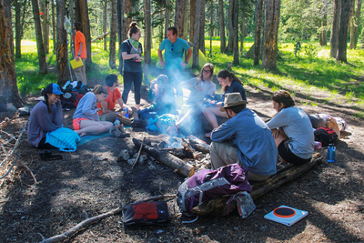 U. of I. students did some experiential learning in the Yellowstone and Grand Teton parks this June in a course on the politics and other issues surrounding national parks. Here the class relaxes before a campfire dinner and discussion.