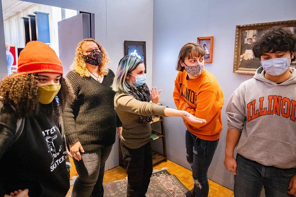 Amber Schultz and Emilie Butt, center, talk about the escape room with Olivia Hamer, Mary Kate Baughman and Duncan McMillan in the escape room.