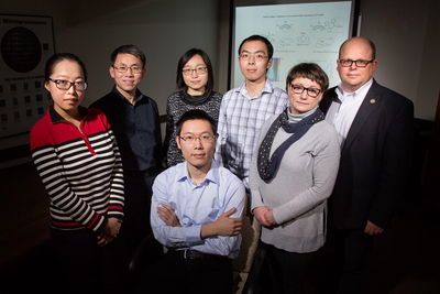 Illinois researchers developed a way to target tumors using sugars that are metabolized by the cancer cell’s own enzymes. From left: postdoctoral researcher Yang Liu, professor Jianjun Cheng, postdoctoral researcher Zhiyu Wang, graduate student Kaimin Cai, research scientist Iwona T. Dobrucka, professor Wawrzyniec Lawrence Dobrucki and graduate student Ruibo Wang (seated).
