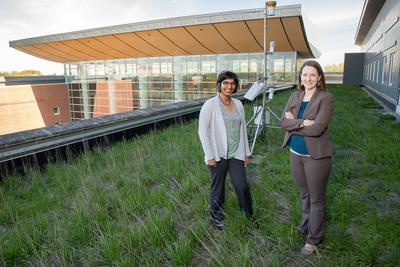 Graduate student Reshmina William, left, and civil and environmental engineering professor Ashlynn Stillwell pause on the green roof over the Business Instructional Facility at the University of Illinois. Their research is helping to simultaneously evaluate the performance of green roofs and communicate their findings with urban planners, policymakers and the general public.