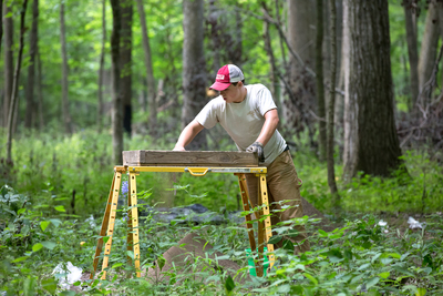 Researchers, including Parkland College student Kaleb Cotter, sift through materials uncovered in excavations of native mounds in Robert Allerton Park.