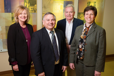Principal investigator Janet Liechty, right, is leading a $1.9 million initiative in the School of Social Work that provides behavioral health services to underserved areas in Illinois. Co-investigators on the project are, from left: assistant dean for field education Mary Maurer; Peter Mulhall, the director of the Center for Prevention Research and Development; and Michael Glasser, an associate dean, U. of I. College of Medicine, Rockford.