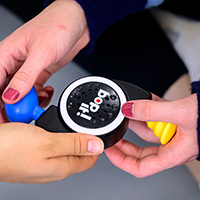Photo of hands holding a Bop It! game.