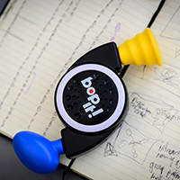 Photo of a Bop It! game sitting on top of notebook pages full of notes.