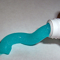 Toothpaste partially squeezed out of its tube.