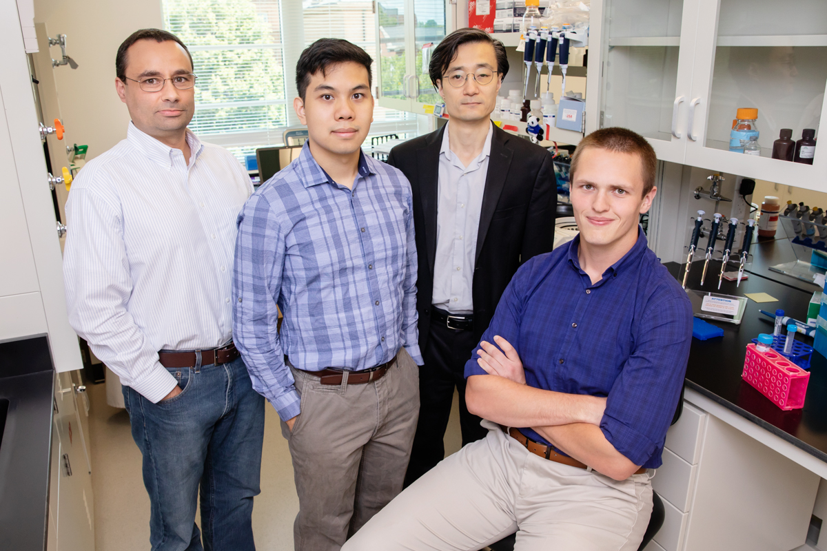 Illinois researchers adapted CRISPR gene-editing technology to help a cell skip over mutated portions of genes. From left, professor Pablo Perez-Pinera, graduate student Alan Luu, professor Jun Song and graduate student Michael Gapinske.