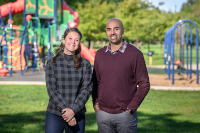 Photo of the researchers standing in front of an outdoor playground.