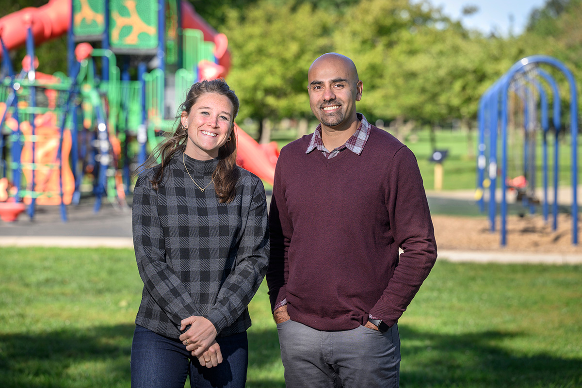 Photo of the researchers standing in front of an outdoor playground.