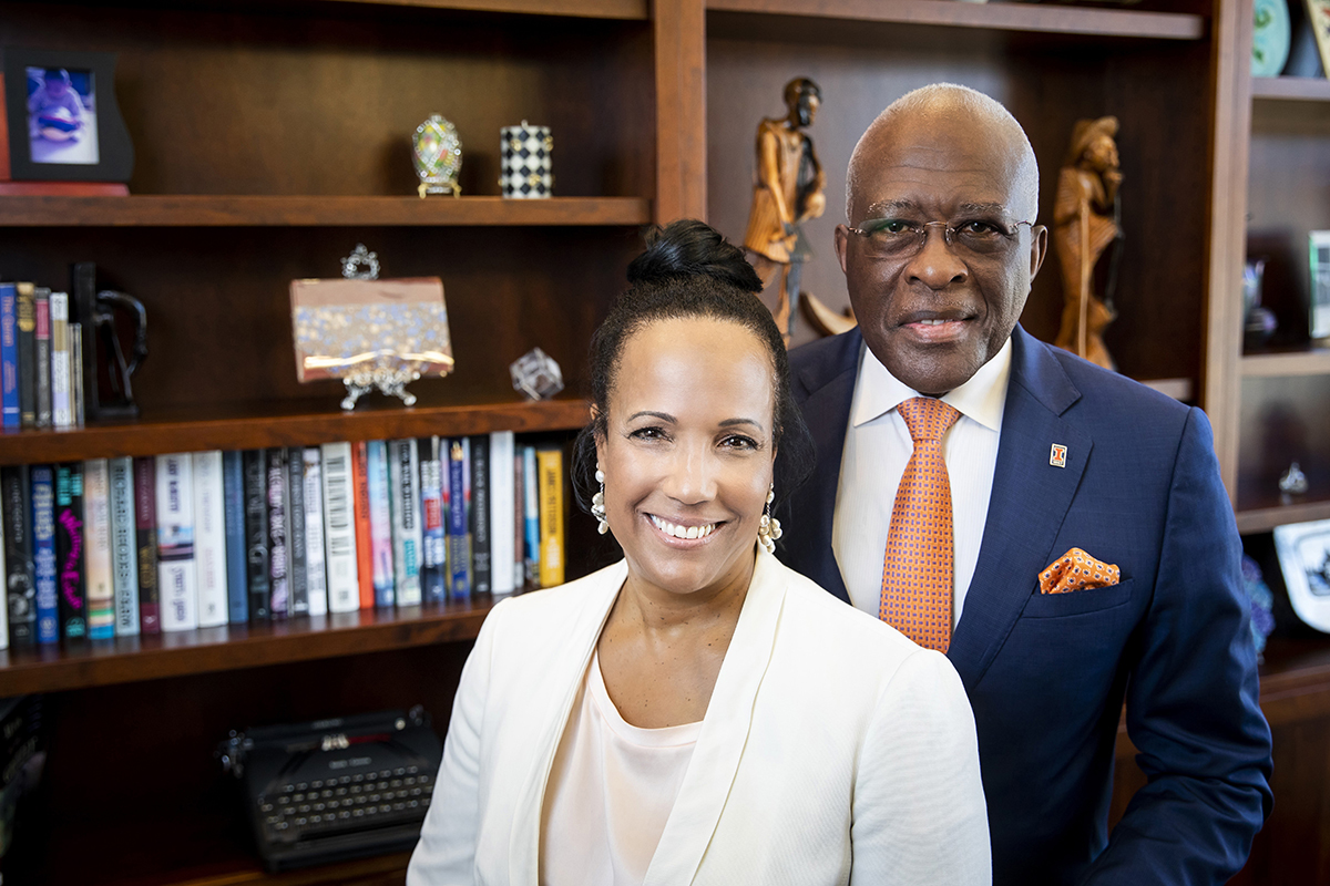 Photo of Chancellor Robert J. Jones and Dr. Lynn Hassan Jones standing in front of library books.